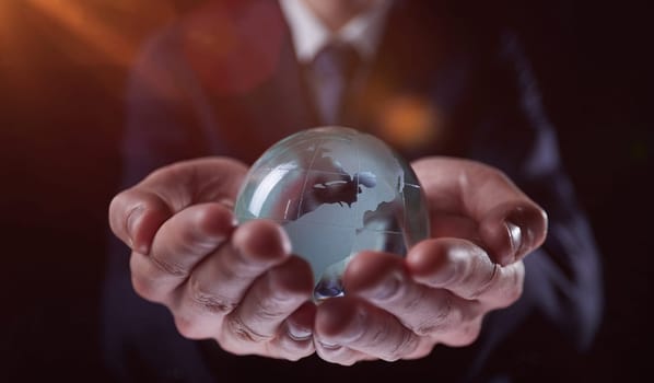 a person holding a small glass globe in their hands, generative AI