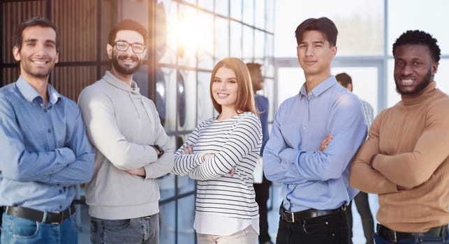 Group of successful businesspeople standing in row and looking at camera at office