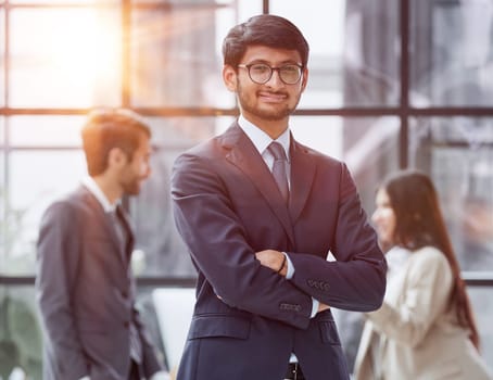Handsome young business man standing confident in the office