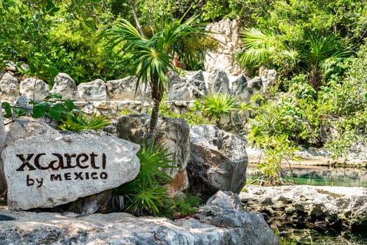 Cancun, Mexico - September 13, 2021: Xcaret theme park sign on a big stone in Mexico