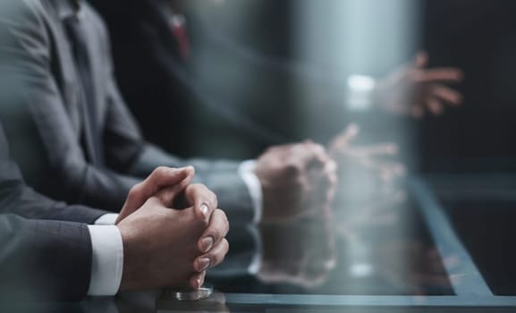 Cropped shot of unrecognizable people, male hands of business people on the table close-up