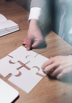 Crop close up of businessman hold pieces of jigsaw puzzle think of business problem solution or idea.
