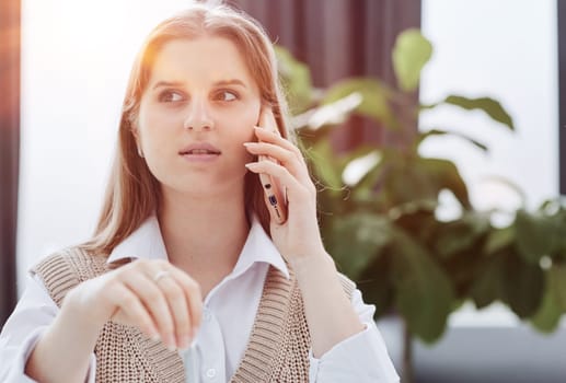 Corporate Communication. Businesswoman Talking On Mobile Phone In Modern Office.