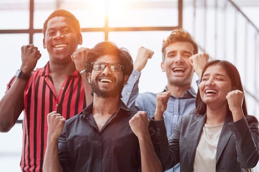 Happy businessmen raise their fists up and laugh. They have training