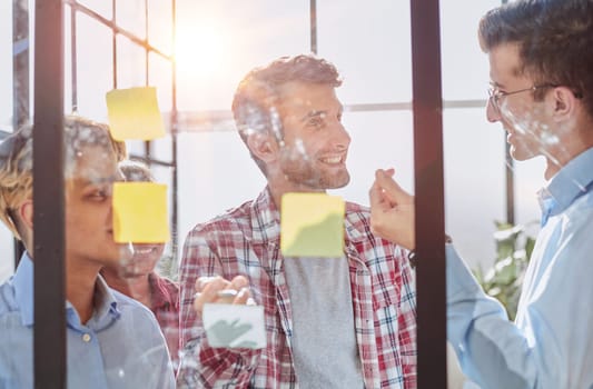 Group of business people behind glass wall at office