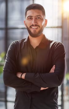 Portrait of successful businessman standing in office