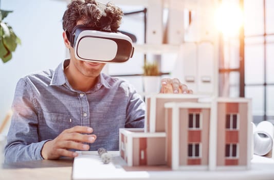 looks at the layout of the apartment in virtual reality glasses.