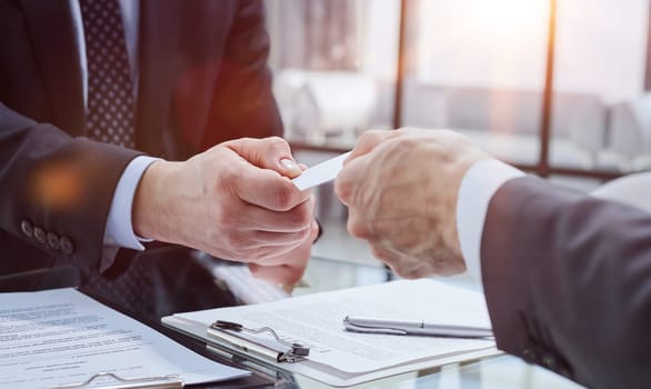 close-up. businessman gives business partner his business card