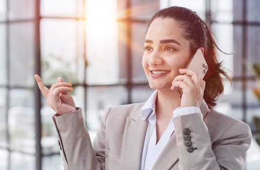 Young charming woman calling with cell telephone