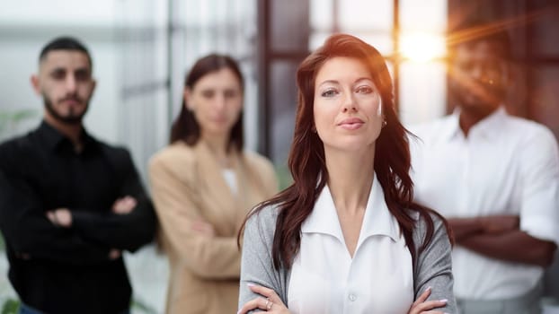 Confident businesswoman posing while looking at camera in front of office