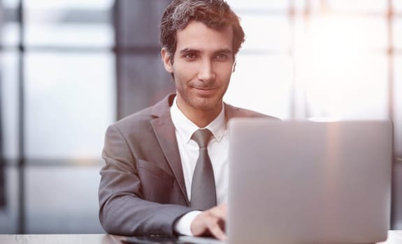Successful businessman working inside office, man in business suit working at workplace with documents and laptop