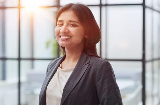 Young confident caucasian serious pretty business woman in office clothes