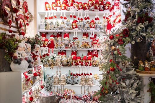 Christmas souvenirs on shelves for sale in the shop, featuring various Christmas toys showcased in the festive store. Embracing the winter holidays concept.