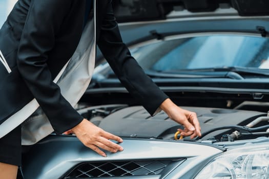 A business woman whose car breakdown try to fix the car by herself without help. uds