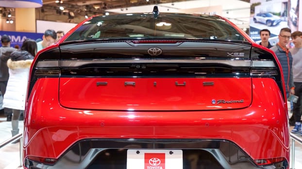 Crowds looking at new car models at Auto show. Toyota Prius car on display. National Canadian Auto Show with many car brands. Toronto ON Canada Feb 19, 2023
