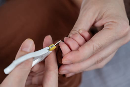 Mom cuts her newborn son's fingernails with small children's scissors