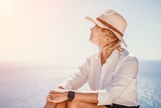 Happy girl doing yoga with laptop working at the beach. beautiful and calm business woman sitting with a laptop in a summer cafe in the lotus position meditating and relaxing. freelance girl remote work beach paradise