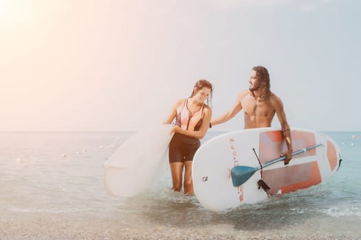 Woman man sea sup. Close up portrait of beautiful young caucasian woman with black hair and freckles looking at camera and smiling. Cute woman portrait in a pink bikini posing on sup board in the sea