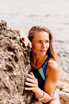 Woman beach vacation photo. A happy tourist in a blue bikini enjoying the scenic view of the sea and volcanic mountains while taking pictures to capture the memories of her travel adventure