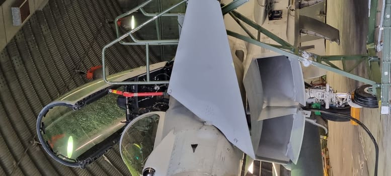 Istrana Italy December 13 2023: Close-up of the ladder and cockpit of an interceptor military aircraft parked in an armored shelter, ready for NATO defense alert takeoff. Includes copy space.