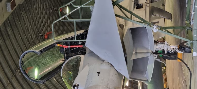 Istrana Italy December 13 2023: Close-up of the ladder and cockpit of an interceptor military aircraft parked in an armored shelter, ready for NATO defense alert takeoff. Includes copy space.