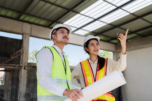 team engineer, foreman, architect meeting for colleagues discussing and checks construction blueprints at onsite.