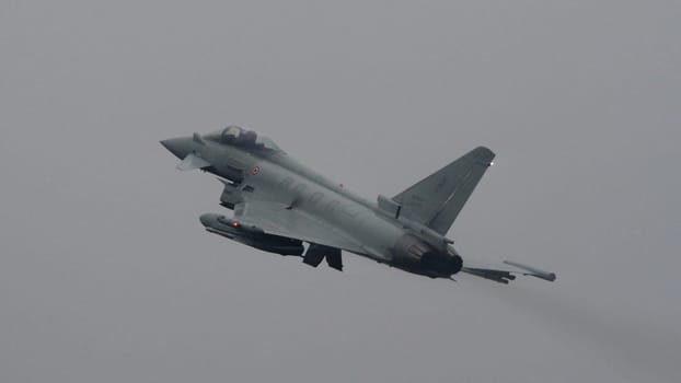Istrana Italy December 13 2023: Showcasing resilience, a NATO supersonic defense aircraft patrols the grey skies on a day of bad weather, affirming airspace security regardless of conditions.
