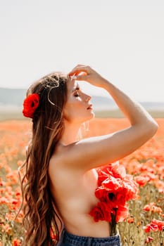 Woman poppies field. portrait of a happy woman with long hair in a poppy field and enjoying the beauty of nature in a warm summer day