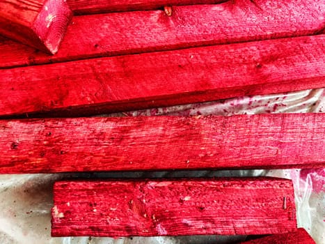 Abstract background with old wooden boards painted with red paint with texture and knots. Pattern, place for text, copy space