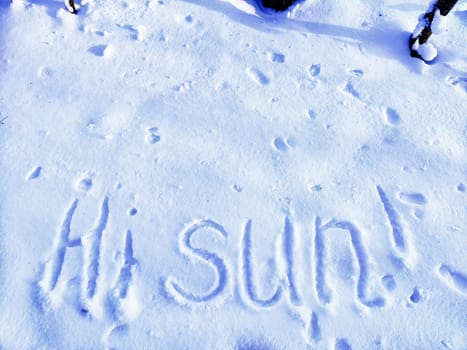 Inscription Hi Summer, written on white background of the snow. Top view. Flat lay. Winter and spring. Waiting for summer and spring