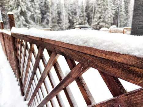 Wooden grate or fence is covered with frost. Frosty freshness on the street in the village. Background, pattern, frame