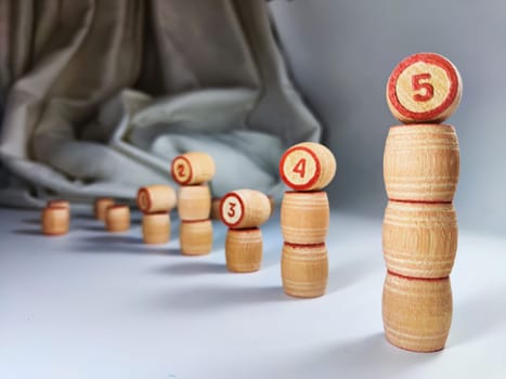 Small wooden barrels with numbers built in columns. The concept of duration and ways to achieve the goal. The sequence of actions to obtain the effect and result