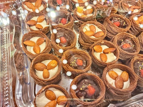 Various types or many colorful assortment of Turkish sweets for sale in shop food festival. Baklava and pastries are sold on trays on the counter. Ramadan, travel
