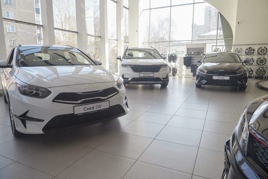 Kirov, Russia - April 12, 2022: Cars in showroom of dealership Kia in Kazan in Russia. Partial focus