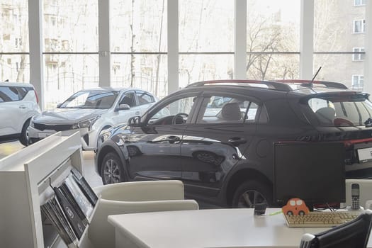 Kirov, Russia - April 12, 2022: Cars in showroom of dealership Kia in Kazan in Russia. Partial focus