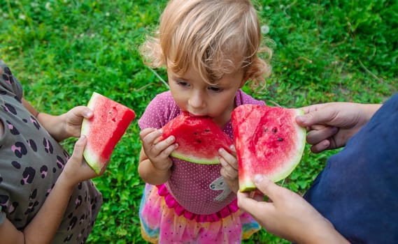Children in the park eat watermelon. Selective focus. Food.