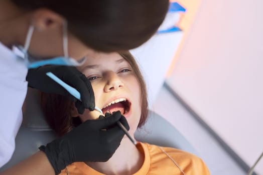 Close up dental treatment procedure in dental office. Dentistry, healthy teeth, medicine and healthcare concept