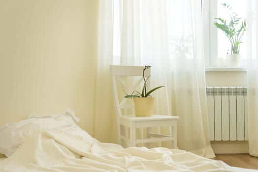 Light pastel bedroom interior, bed, white chair, window light curtains