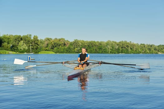 Active healthy lifestyle teens. Boys 15, 16 years old paddling sport kayak. Teenagers carrying two-seater sports boat