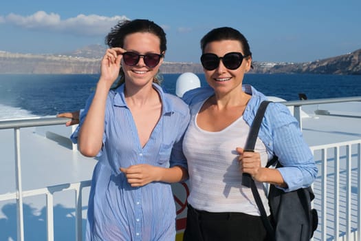 Family travel luxury cruise vacation, mother and teenage daughter enjoy sea trip on deck of liner on sunny summer day