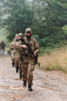 A disciplined and specialized military unit, donned in camouflage, strategically patrolling and maintaining control in a high-stakes environment, showcasing their precision, unity, and readiness for special operations.