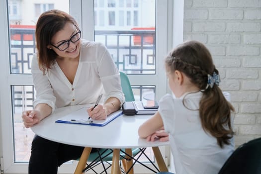 Communication session of school psychologist and girl 9, 10 years. Child tells psychotherapist his experiences, mental health of children