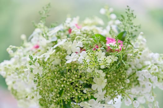 Springtime, spring fresh bouquet of lilies of the valley, pink roses, blooming viburnum. Texture, background