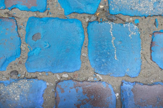 Blue stone texture, vintage paving stones painted blue wet shiny from rain