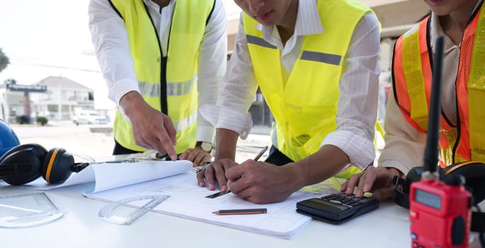 Civil engineering team meets to plan work on construction project in the construction area Foreman, industrial project manager, engineer working as a team Professional team in Asian industry.