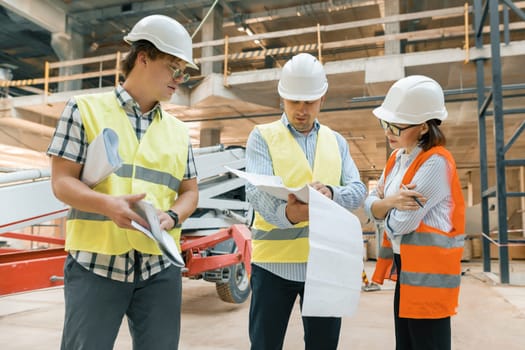 Female construction inspector examining construction site. Building, development, teamwork and people concept.