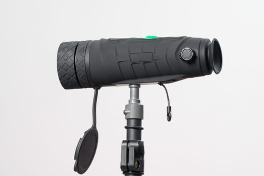 Monocular on a tripod isolated on a white background, monocular for military action.