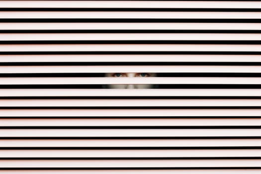 Scary eye peek out of strip lines abstract concept of unhappy vision minimal comeliness