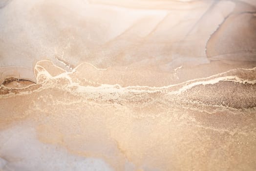 Tender and dreamy design. Luxury abstract fluid art painting in alcohol ink technique, mixture of bronze, silver, metallic and gold paints. Imitation of marble stone cut, glowing golden veins.