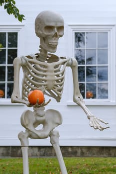 Elaborate Halloween Decorations Of A Giant Skeleton And Pumpkin Outside A House In A US Suburb